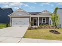 Beautifully landscaped single-Gathering home with a well-maintained lawn and two-car garage at 1025 Quindell Dr, Holly Springs, NC 27540
