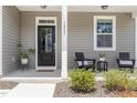 Inviting front porch featuring a cozy seating area and stylish decor at 1025 Quindell Dr, Holly Springs, NC 27540