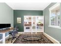 Stylish home office with a desk, chair, shelves and decorative rug at 1025 Quindell Dr, Holly Springs, NC 27540