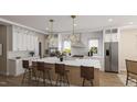 Bright, spacious kitchen featuring a center island, stainless steel appliances, and modern lighting fixtures at 135 Gary Rd, Carrboro, NC 27510