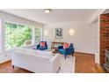Cozy living room with large windows, stylish decor, and brick floors at 1409 Valley Run, Durham, NC 27707