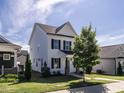 Attractive home with white siding, dark shutters, and a perfectly kept lawn at 157 E Wilson St, Clayton, NC 27520