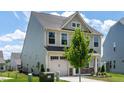 View of home's side and front highlighting siding, garage, and landscaping details at 1745 Ripley Woods St, Wake Forest, NC 27587