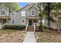 Charming two-story home featuring a covered front porch, brick stairs, and tidy landscaping at 1815 Crystal Downs Lane, Raleigh, NC 27604