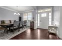 Formal dining area with hardwood flooring, crown molding, and a window letting in natural light at 184 Elgin Ct, Burlington, NC 27215