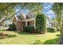 Green home with brick details and well-maintained landscaping at 20002 Fountain, Chapel Hill, NC 27517