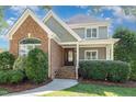 Charming home with brick and siding, front yard landscaping, and a welcoming entrance at 20002 Fountain, Chapel Hill, NC 27517