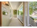 Inviting front porch with classic columns, white railings, and a decorative wreath, creating a welcoming entrance at 20002 Fountain, Chapel Hill, NC 27517