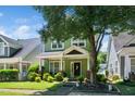 Charming two-story home with a inviting front porch and beautifully landscaped front yard at 2112 Dunn Rd, Raleigh, NC 27614