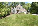 Charming two-story home with a brick facade, well-manicured lawn, and mature landscaping at 217 Dalmeny Dr, Cary, NC 27513