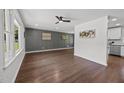 Bright living room with hardwood floors, large windows, ceiling fan, and open layout at 2317 Bertie Dr, Raleigh, NC 27610