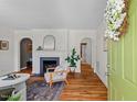 Bright living room with hardwood floors, fireplace, and arched doorways, showcasing classic charm at 2504 State St, Durham, NC 27704