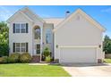 Beautiful two-story home with attached two-car garage, manicured landscaping, and inviting front entrance at 2644 Bloomsberry Ridge Dr, Fuquay Varina, NC 27526