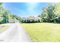 Spacious home with lush green lawn, outbuilding, and long driveway at 3564 Lower Moncure Rd, Sanford, NC 27330