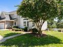 Charming townhome with manicured lawn, mature tree and lake view at 400 Nottinghill Walk, Apex, NC 27502