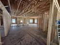 Spacious interior view of the unfinished home showcasing exposed framing and concrete flooring at 4026 N Nc 581 Hwy, Kenly, NC 27542