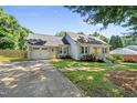 Attractive home featuring a single-car garage, well-maintained lawn, and a classic brick and siding combination at 405 E Millbrook Rd, Raleigh, NC 27609