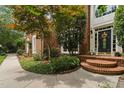 Close-up of the front door showcasing the entryway, landscaping, and brick facade at 409 Englewood Dr, Chapel Hill, NC 27514