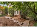 Landscaped side yard with brick pathway and well-maintained greenery at 409 Englewood Dr, Chapel Hill, NC 27514