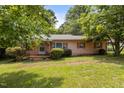 Charming single-story home with a well-maintained front yard and mature landscaping at 416 Forrest St, Hillsborough, NC 27278