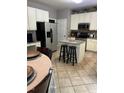 Eat-in kitchen featuring white cabinets, a center island, and stainless steel appliances at 433 Turnberry Dr, Mebane, NC 27302