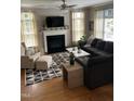 Cozy living room with a fireplace, neutral decor, and a large sectional sofa at 433 Turnberry Dr, Mebane, NC 27302