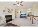 Spacious living room features a fireplace, large TV, and seamless flow to the dining area at 453 Panorama Park Pl, Cary, NC 27519
