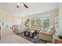 Bright living room boasts plush seating, natural light from large windows, and ceiling fan at 453 Panorama Park Pl, Cary, NC 27519