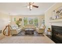 Cozy living room featuring comfortable seating, a fireplace, and lots of natural light at 453 Panorama Park Pl, Cary, NC 27519