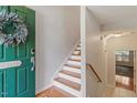 Inviting entryway with wood floors, white stairs, and stylish front door decor at 4533 Pale Moss Dr, Raleigh, NC 27606