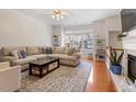 Bright living room with hardwood floors, large windows, and cozy fireplace at 4533 Pale Moss Dr, Raleigh, NC 27606