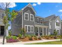 Attractive two-story gray home with white trim and colorful landscaping at 4716 Crescent Square St # 1314, Raleigh, NC 27616