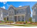 A gray two-story home featuring well-manicured landscaping with a mulch bed at 4716 Crescent Square St # 1314, Raleigh, NC 27616