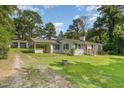 View of charming one-story home and detached garage with well-maintained lawn and driveway at 500 Ellen Dr, Knightdale, NC 27545
