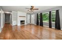 Spacious living room with hardwood floors, fireplace, and natural light from large windows at 500 Ellen Dr, Knightdale, NC 27545