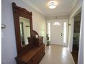 Bright foyer featuring neutral tile, a white front door, and a decorative wood bench at 5112 Stephens Ln, Durham, NC 27712