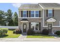 Charming townhome featuring a brick exterior and a well-maintained front yard at 523 Berry Chase Way, Cary, NC 27519