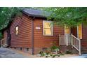 Exterior view of home with address, tidy yard, mature trees, and lush landscaping at 5315 Mccormick Rd, Durham, NC 27713