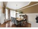 Dining room featuring hardwood floors, modern lighting, and wainscoting at 553 Lake Gaston Dr, Fuquay Varina, NC 27526