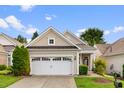 Charming home with a two-car garage, beautiful siding, and manicured lawn at 575 Tomkins Loop, Cary, NC 27519