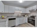 Well-lit kitchen with stainless steel appliances, white cabinets, and granite countertops at 5905 Westcreek Pl, Raleigh, NC 27606