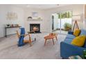 Bright living room with a cozy fireplace, neutral carpet, and a sliding door to the outside at 6 Parsons Chase Ln, Durham, NC 27713