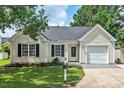 Charming single-story home with a tidy front yard and attached single car garage at 611 Quartz Dr, Durham, NC 27703