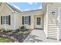 Cozy home featuring a welcoming front porch and meticulous landscaping at 611 Quartz Dr, Durham, NC 27703