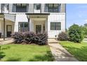Close up of a townhouse exterior with a well-kept lawn and attractive landscaping at 6300 Pleasant Pines Dr # 101, Raleigh, NC 27613