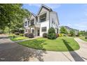 Townhouse exterior featuring modern design, manicured lawn, and inviting curb appeal at 6300 Pleasant Pines Dr # 101, Raleigh, NC 27613