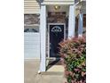 Close up of front door with stone facade and attractive shrubbery at 650 Ganyard Farm Way # 32, Durham, NC 27703