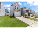 Attractive townhome exteriors with landscaped front yards and attached garages at 706 Ambrose Hill Lane Ln, Wendell, NC 27591