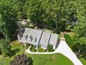 Aerial view of a well-maintained home with a spacious yard and mature trees at 7917 Rooksley Ct, Raleigh, NC 27615