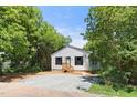 Charming single-story home with white siding, dark shutters, and a welcoming wooden porch at 810 Williams St, Burlington, NC 27217